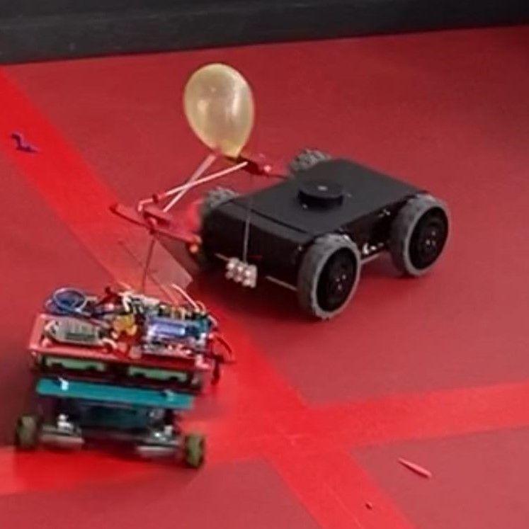 A robot with a balloon and a car

Description automatically generated with medium confidence