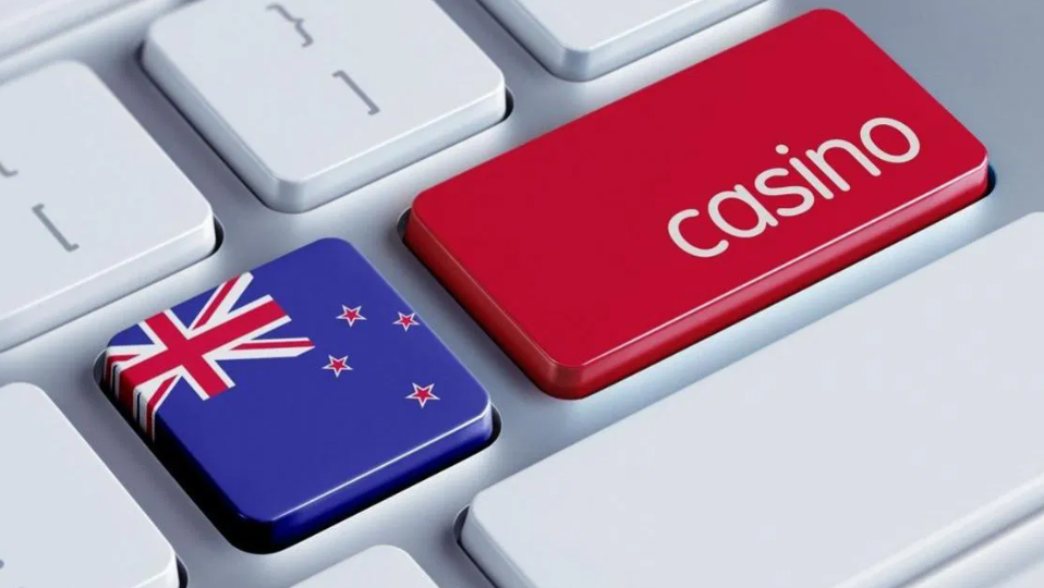 The flag of New Zealand overlaid on a keyboard with casino-related keys, symbolizing the country's focus on regulating online gambling NZ through casino gambling licenses and gambling ads bans.
