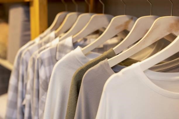 Clothes hanging on a hanger in a store Clothes hanging on a hanger in a store sweatshirts stock pictures, royalty-free photos & images