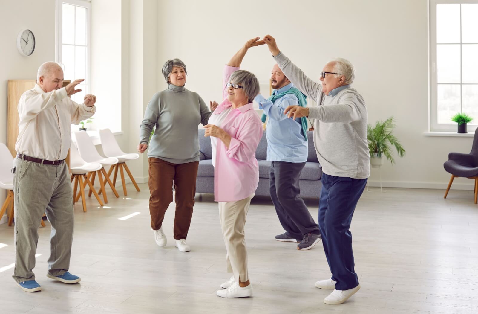 Seniors enjoying a dance during a social event at an independent living community.