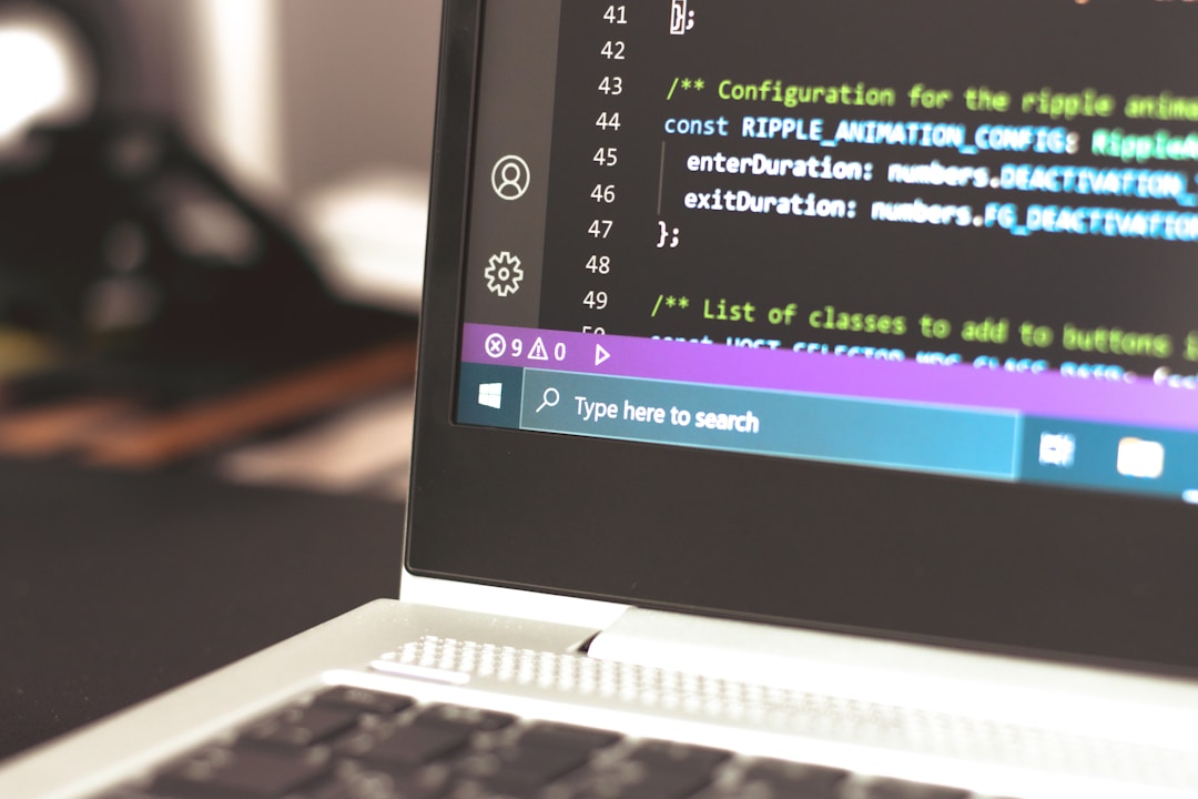 A laptop displaying code on the screen, highlighting the best AI enterprise search software.