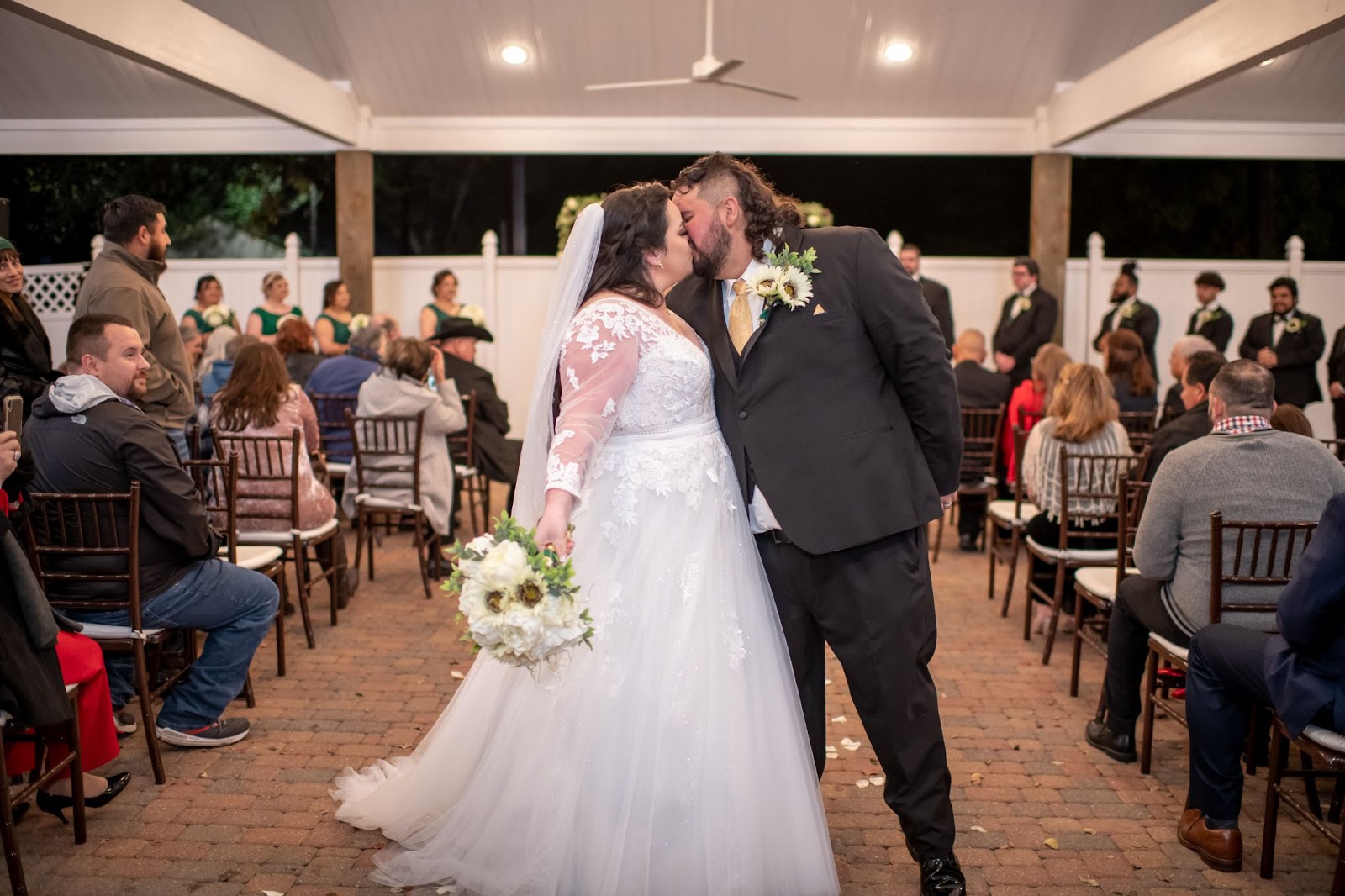 Bride and Groom share a kiss at the end of the aisle after their pavilion wedding ceremony