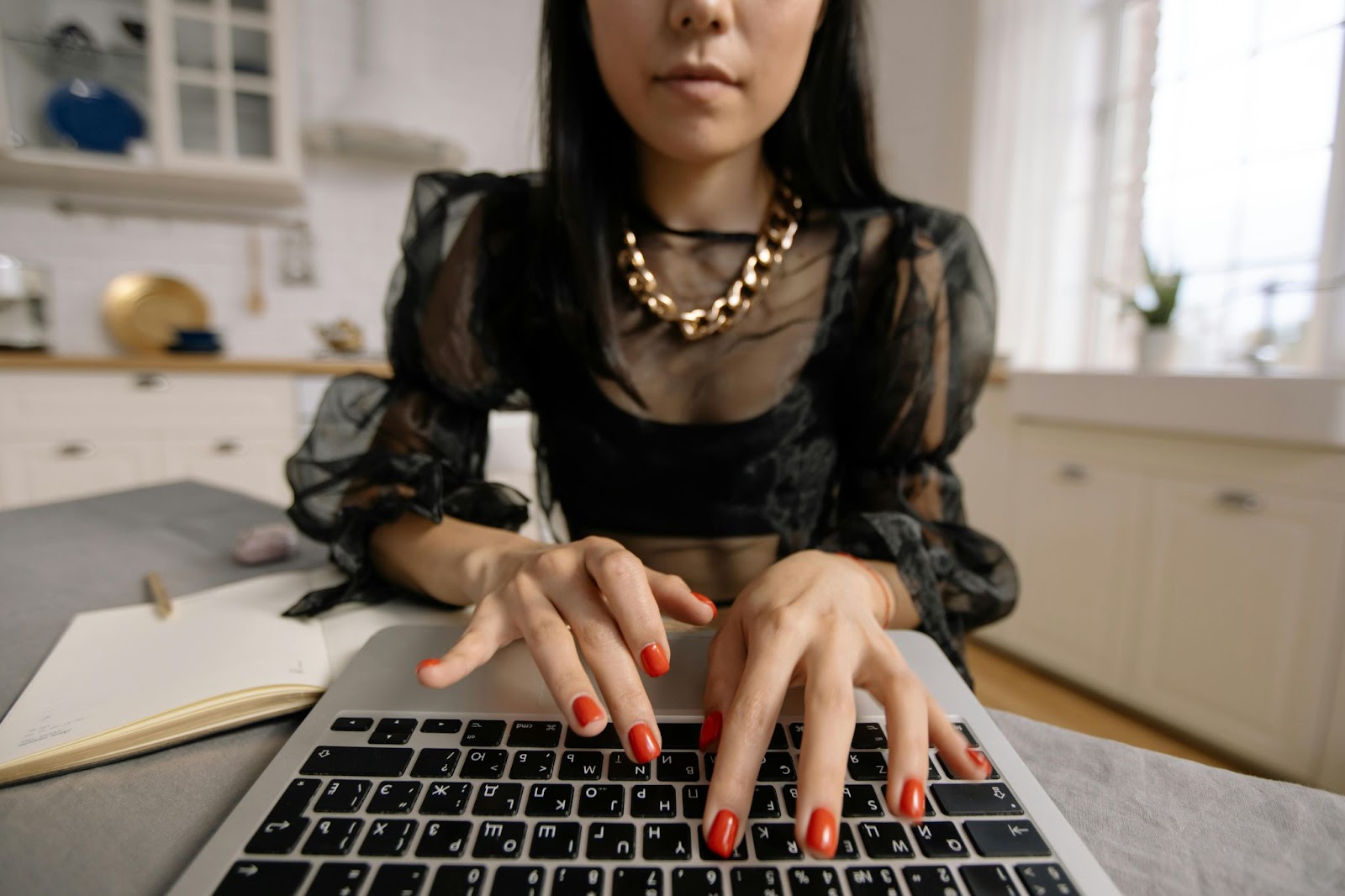 image of a lady typing on a laptop.