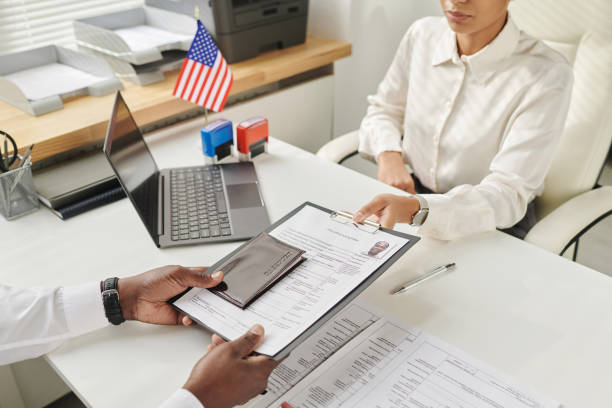 Applicant submitting work visa documents at U.S. embassy