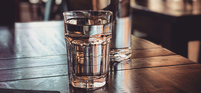 Glass of water on a restaurant table.