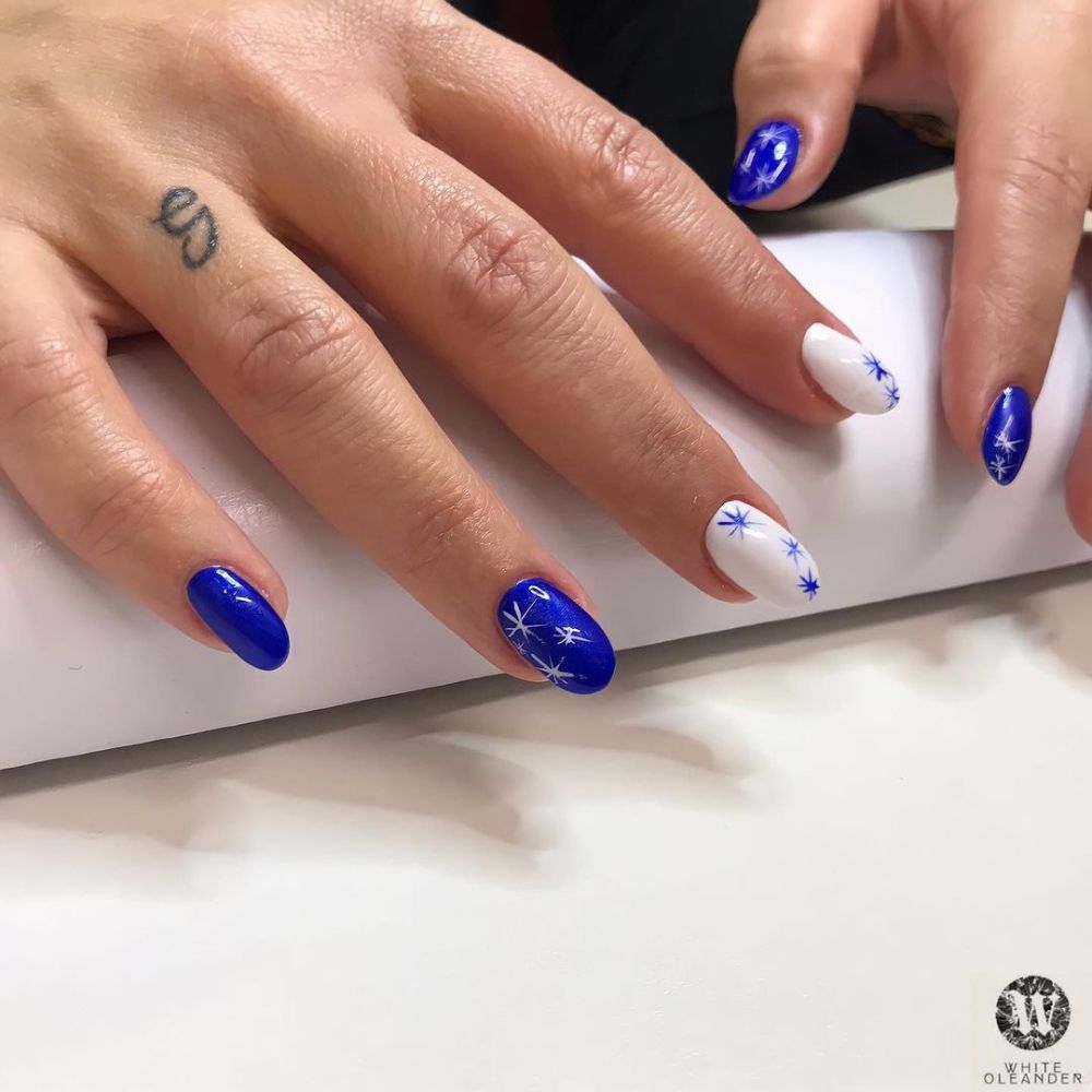 Close up of hands with blue winter nails having starry nails