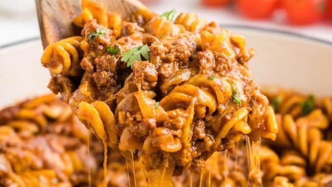 A spoon serving Beef Enchilada Pasta.