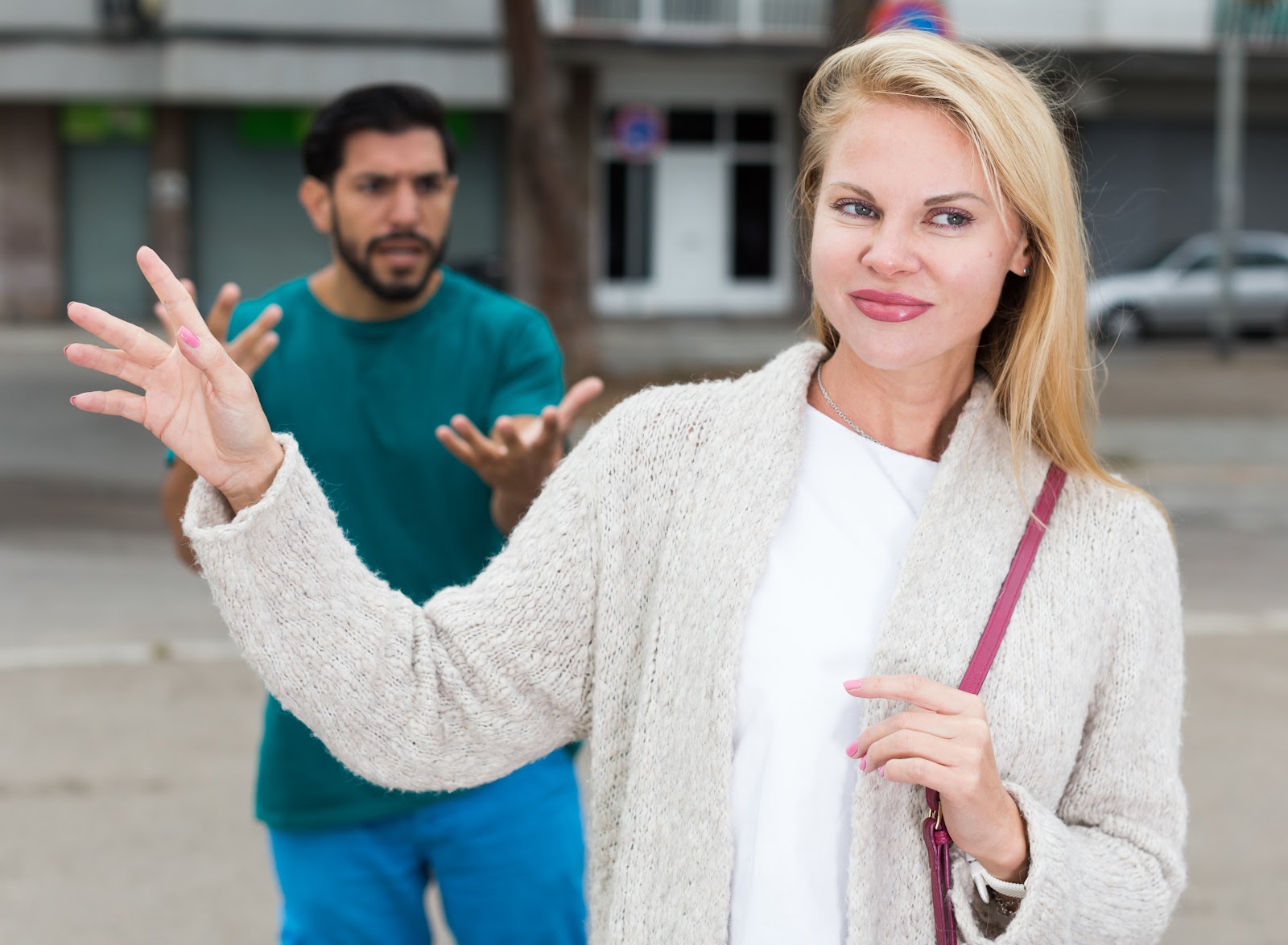 A woman smiling, leaving after an argument | Source: Getty Images