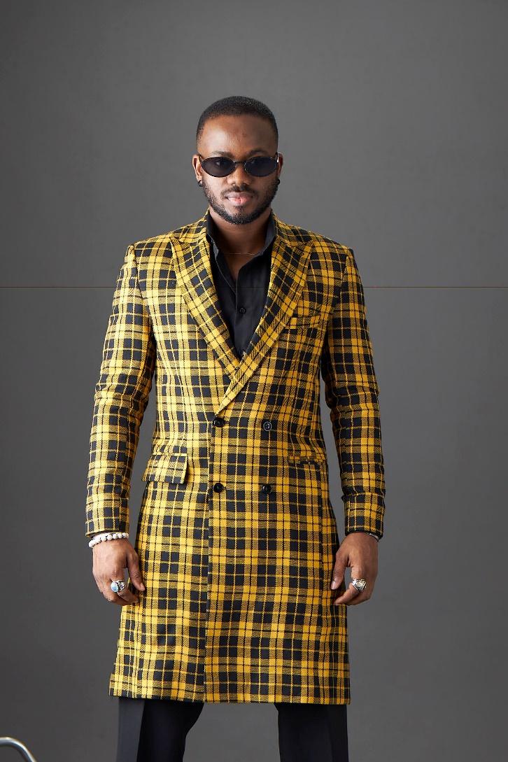 A person wearing a yellow and black plaid suit

Description automatically generated