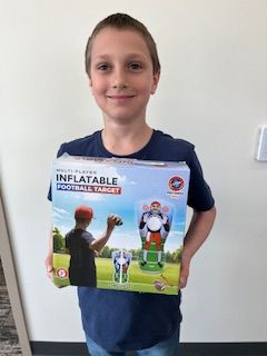 Ignacy holding a prize