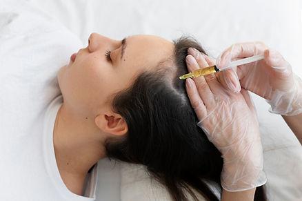 A female taking syringe on her scalp