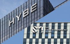 This contain an image of  the hybe logo is on top of an office building