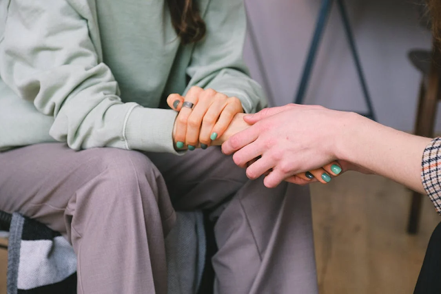 physiotherapist comforting patient