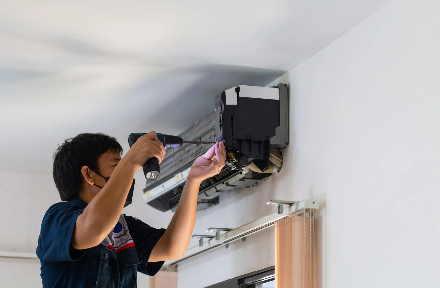 HVAC technician working on a ptac unit