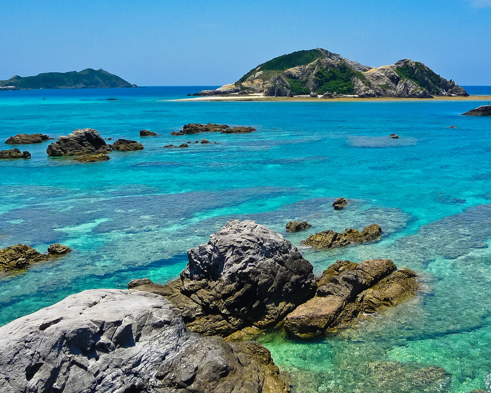 Okinawa Island with clear blue water and rocks.