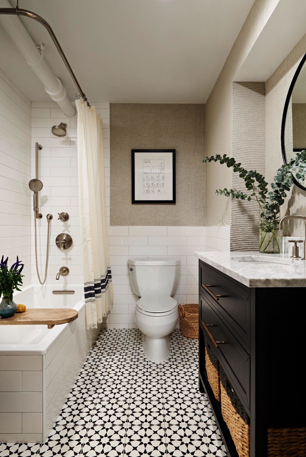 Full bath with a tub-shower combo, white subway tile, nickel fixtures, patterned floor tile, and a black vanity