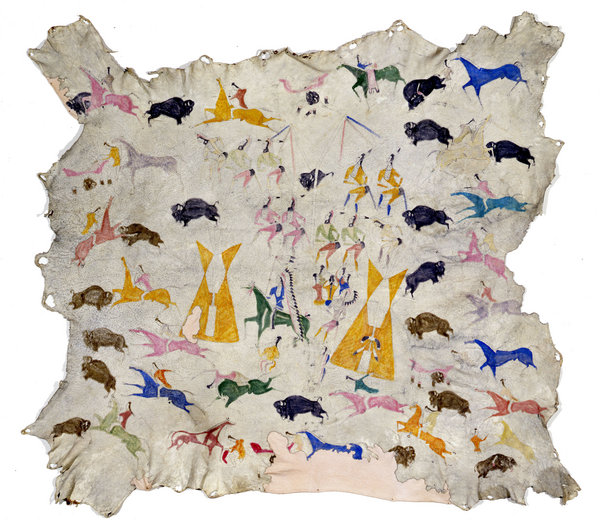 Painted animal hide. Colorful depictions of human, animal, and decorative images adorn a white background.
This painted hide shows figures of humans and animals all engaged in dynamic activities. Colors include pink, blue, brown, black, green, orange, yellow, and red, on a white background. Each figure is separate and distinct from the others, with very little overlap. In addition to the human and animal figures, there are two geometric stylizations of what appear to be human-made structures. The overall sense is of vigorous movement, speed, and clashing of forces in a narrative that plays out in multiple, simultaneous scenes.

