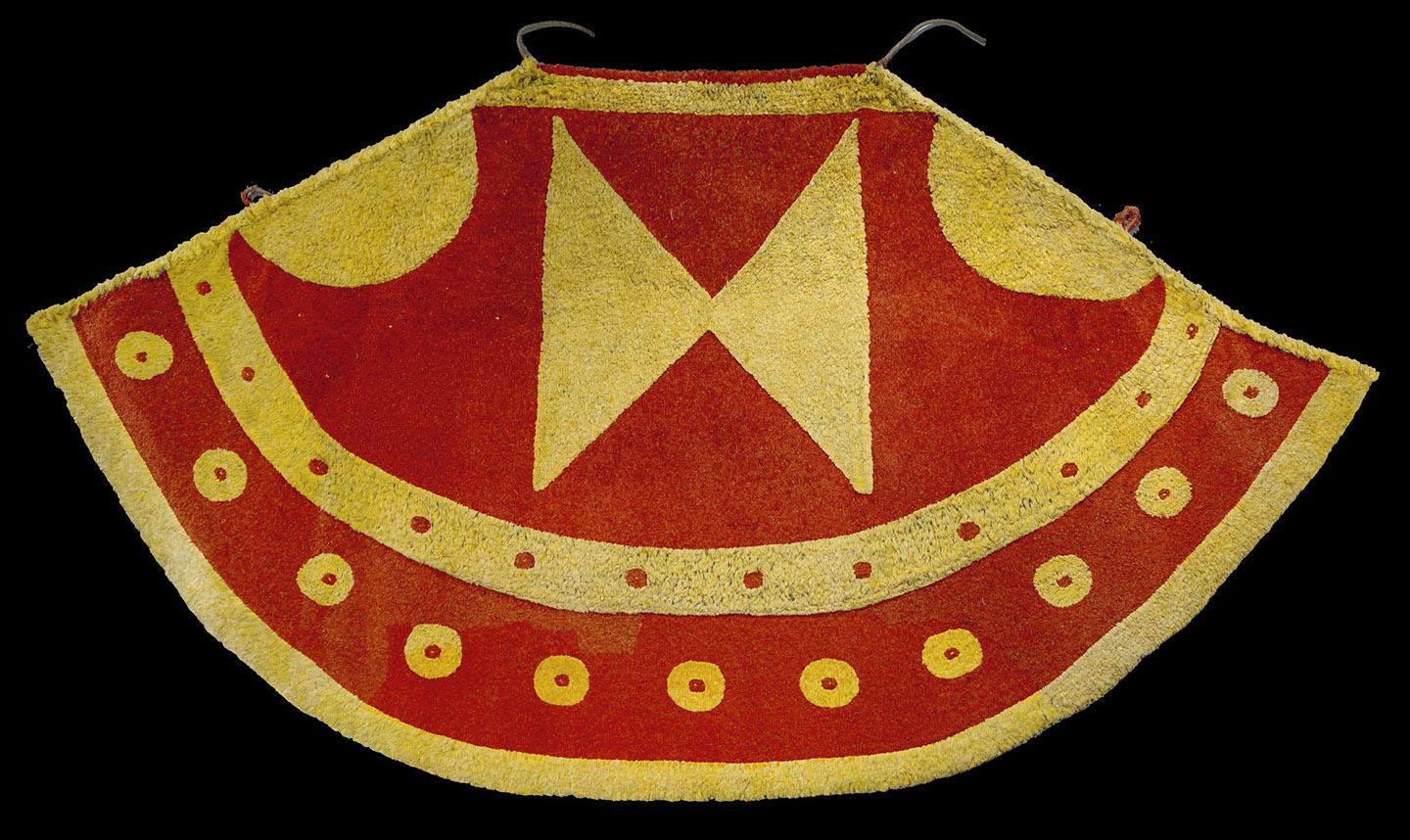 A red and yellow apron with a cross on it

Description automatically generated