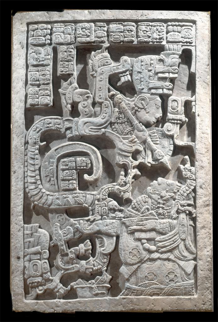 Sculpture. Relief sculpture depicting serpentine and human figures intertwined, with a pictorial inscription.
This relief sculpture depicts a woman reclining and holding a bowl in her hands. Above her is a human figure, apparently emerging from the mouth of a serpent that winds around pictorial inscriptions. The figure brandishes a spear-like object, pointed at the woman. The entire composition is full of geometric patterns and organic shapes.

