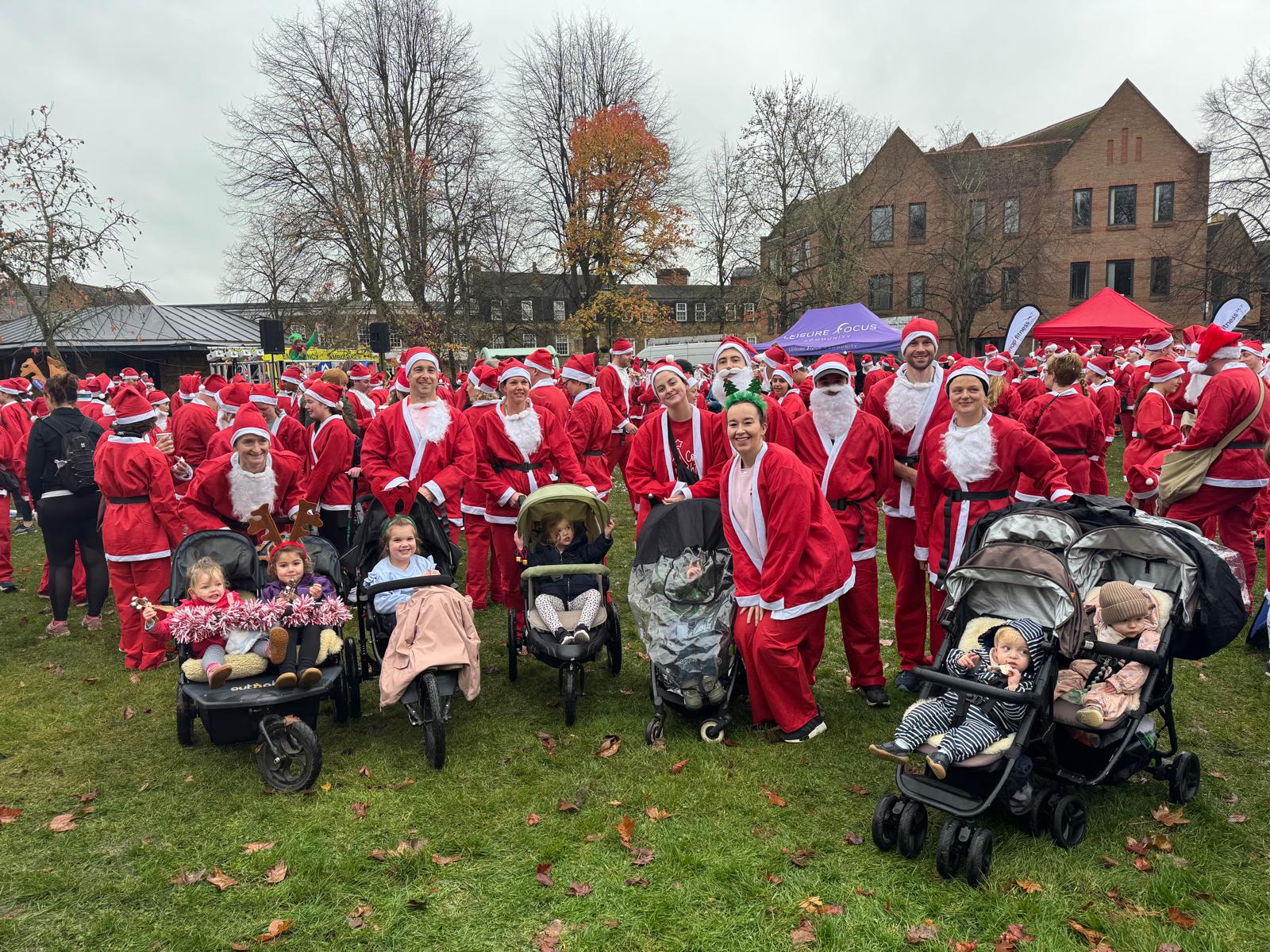 A group of people in santa outfits

Description automatically generated