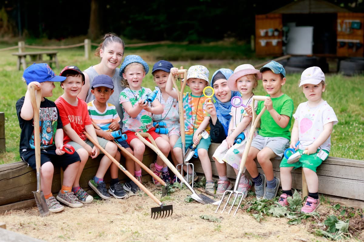 A group of children and a person posing for a photo

Description automatically generated
