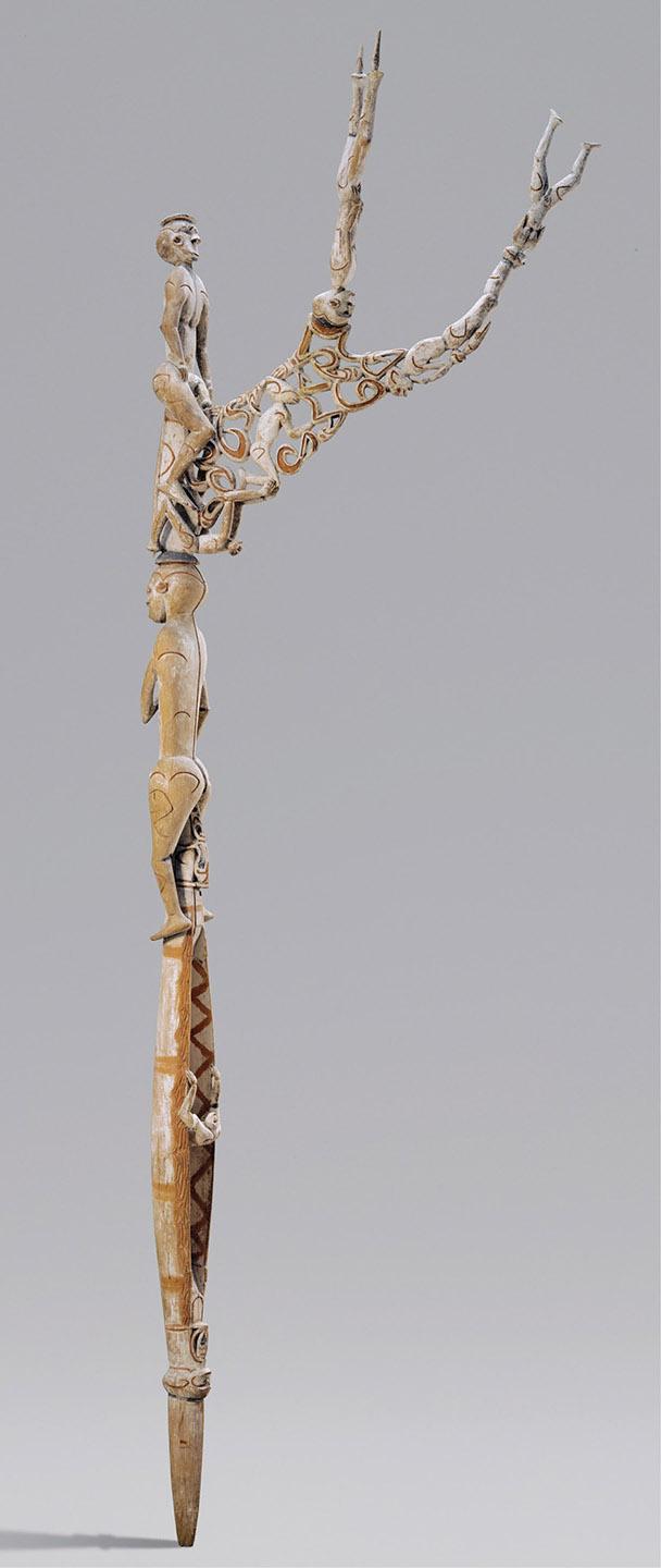 A statue of a person holding an object

Description automatically generated
