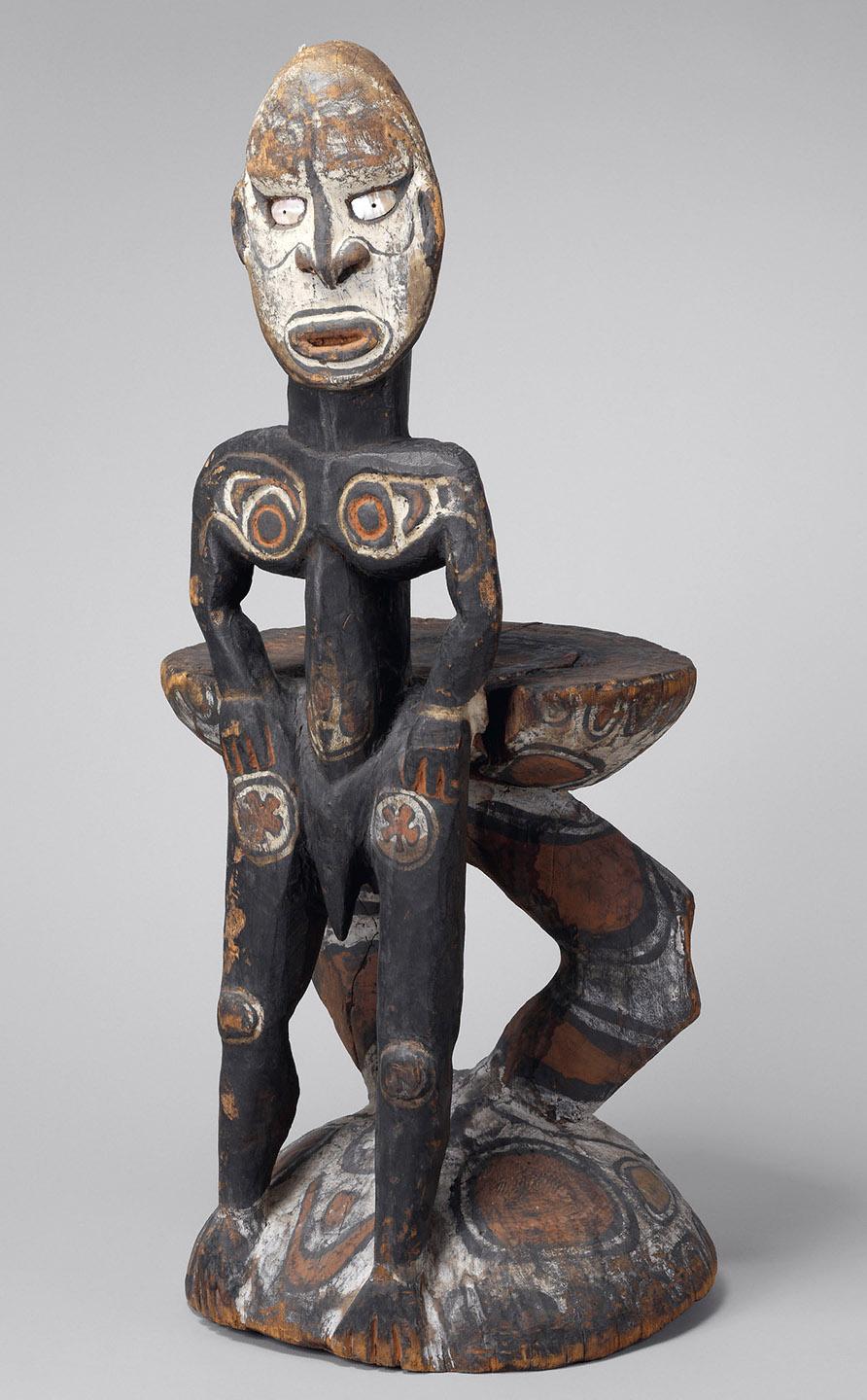 A wooden statue of a person

Description automatically generated