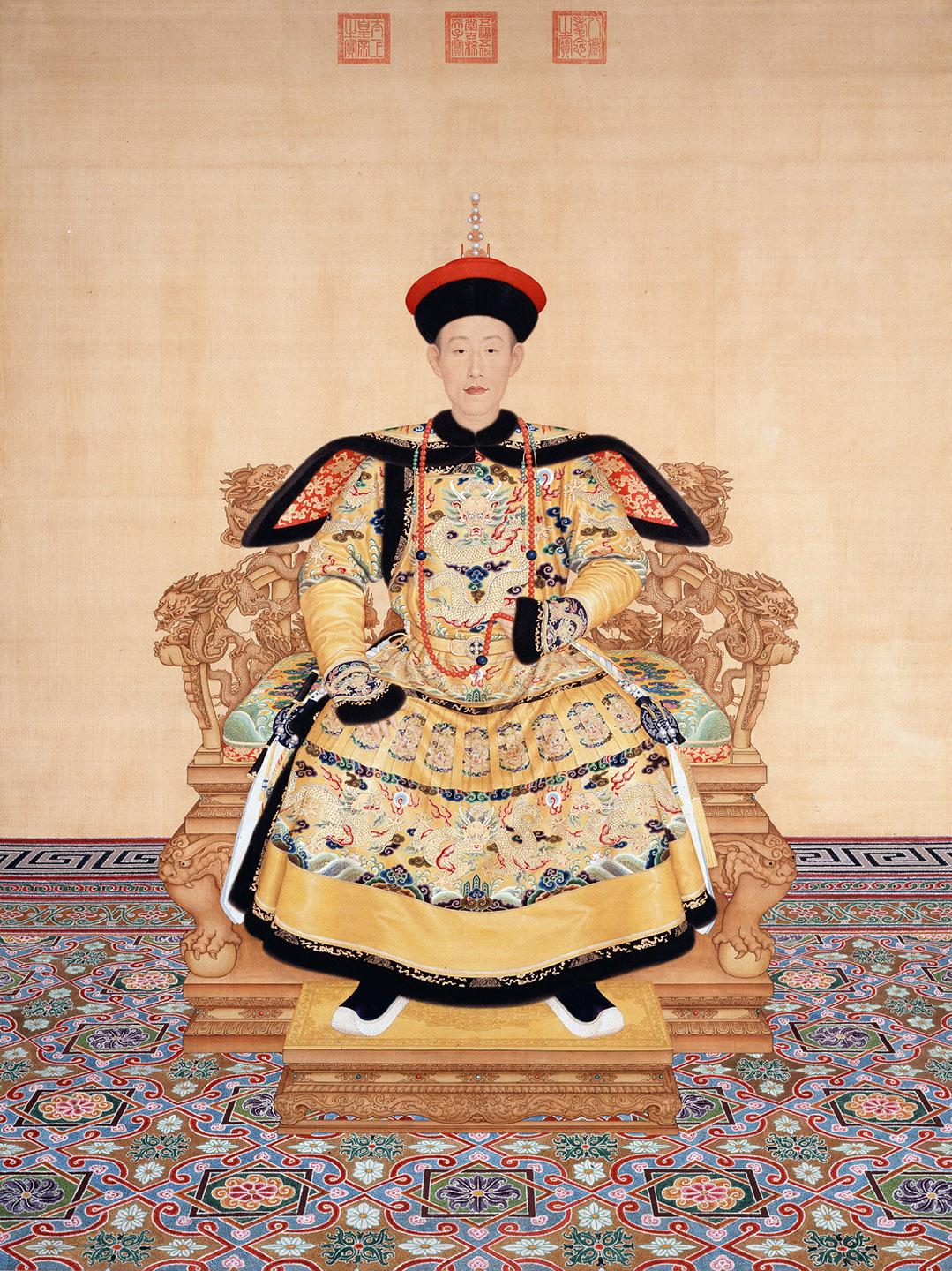 A person in a traditional garment sitting on a chair<br /><br />Description automatically generated